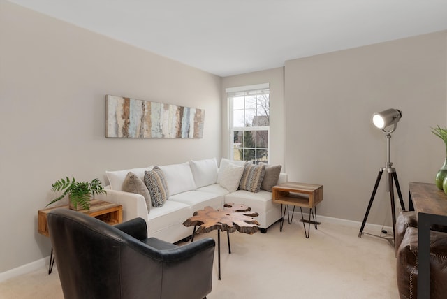 living area featuring light carpet and baseboards