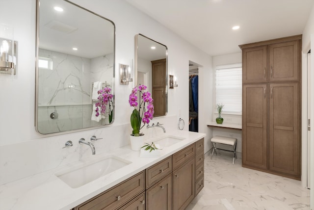 full bath with double vanity, recessed lighting, marble finish floor, and a sink