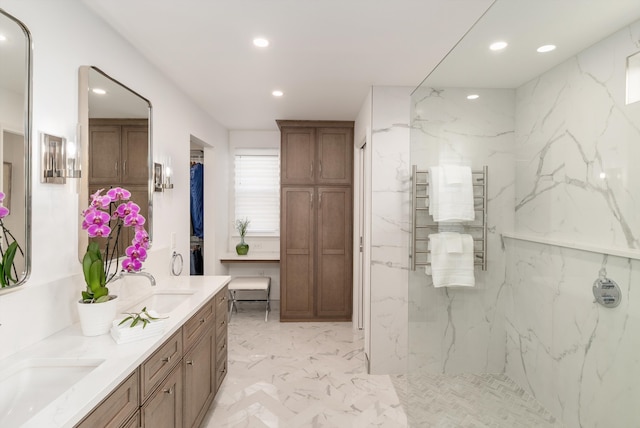 bathroom with double vanity, recessed lighting, marble finish floor, and a sink