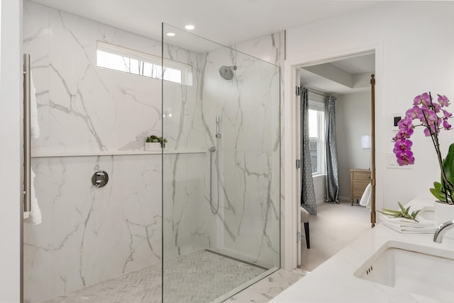 full bathroom featuring ensuite bathroom, recessed lighting, a marble finish shower, and a sink