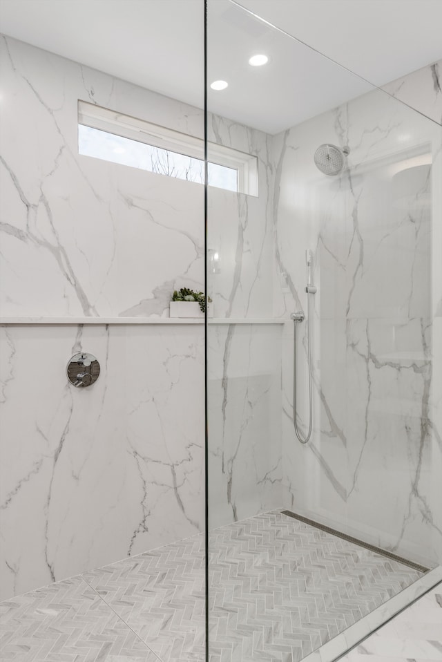 bathroom featuring recessed lighting, a marble finish shower, and a healthy amount of sunlight