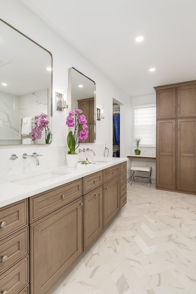 bathroom featuring double vanity, recessed lighting, marble finish floor, and a sink