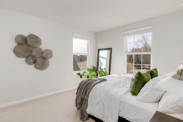 carpeted bedroom with baseboards