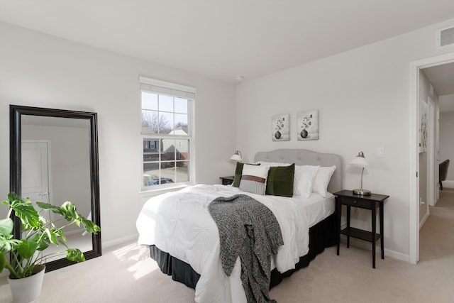 bedroom with baseboards and carpet