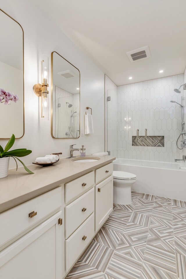 full bathroom with vanity, visible vents, shower / bath combination, tile patterned floors, and toilet