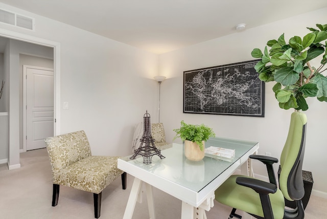 home office featuring baseboards, visible vents, and light carpet