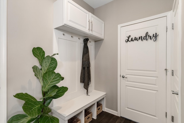 mudroom featuring dark wood-type flooring and baseboards