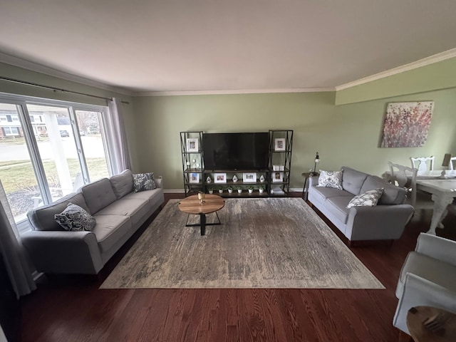 living area with baseboards, wood finished floors, and crown molding