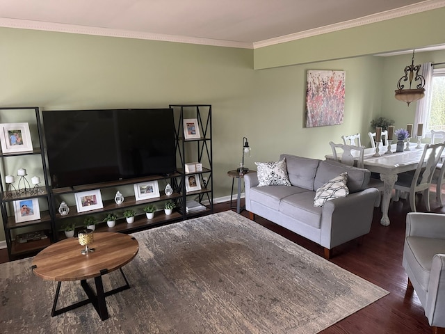 living area featuring an inviting chandelier, wood finished floors, baseboards, and ornamental molding