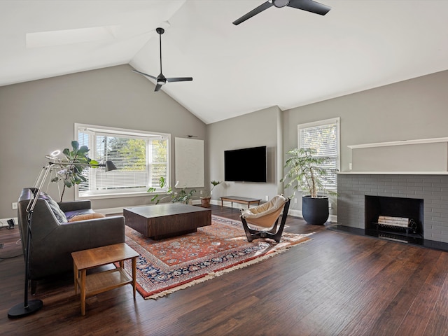 living room with a brick fireplace, plenty of natural light, wood finished floors, and ceiling fan