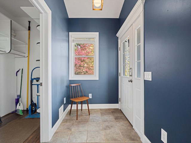 interior space with light tile patterned floors, baseboards, and visible vents