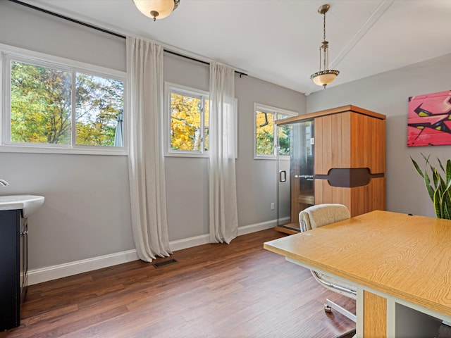 dining space with visible vents, baseboards, lofted ceiling, and wood finished floors