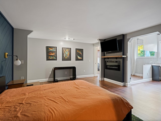 bedroom with baseboards and wood finished floors