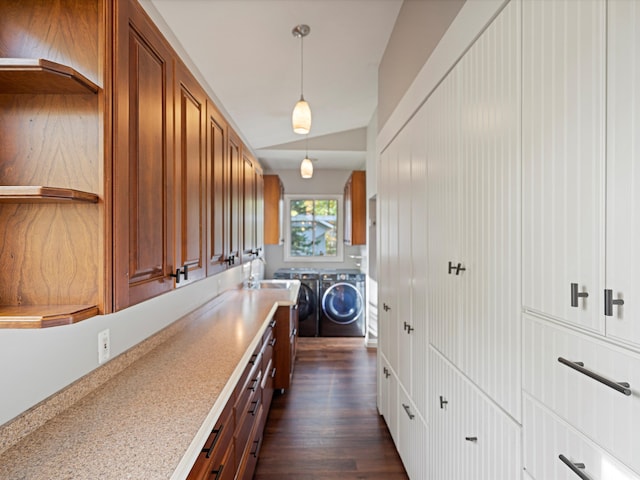 laundry room featuring washing machine and clothes dryer, laundry area, and dark wood-style flooring