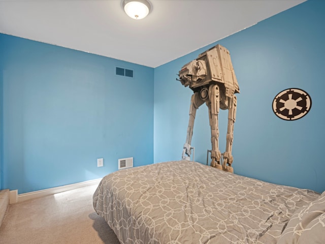 carpeted bedroom with visible vents and baseboards