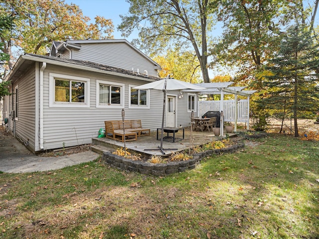 back of house with a yard and a pergola