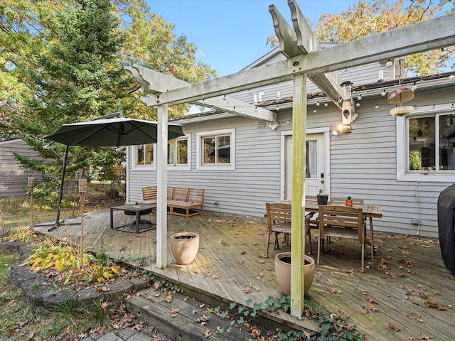 deck featuring outdoor dining area and a pergola