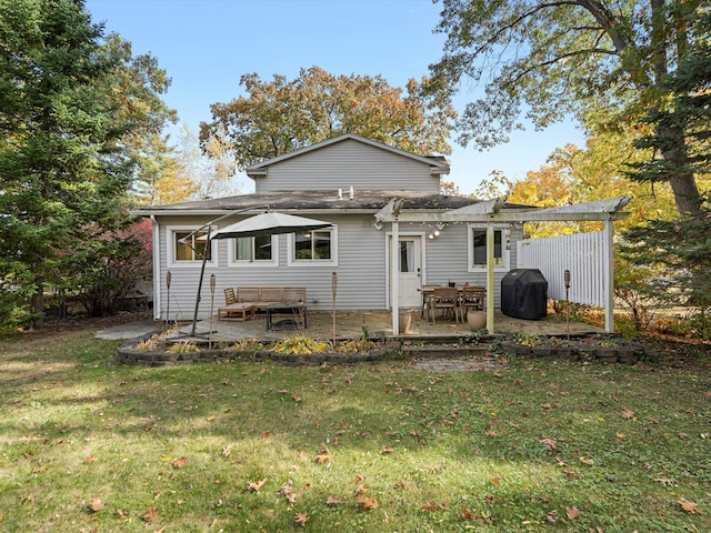 rear view of property with a patio and a lawn