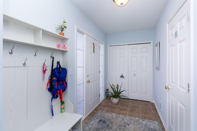 mudroom featuring tile patterned floors and baseboards