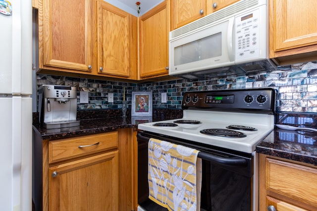 kitchen with decorative backsplash, dark stone countertops, and white appliances