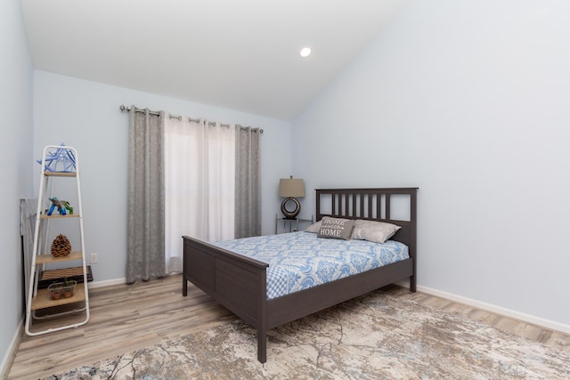 bedroom featuring recessed lighting, baseboards, lofted ceiling, and wood finished floors