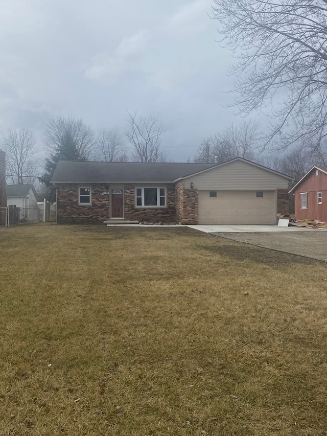 view of front of home with a front yard, an attached garage, fence, and driveway