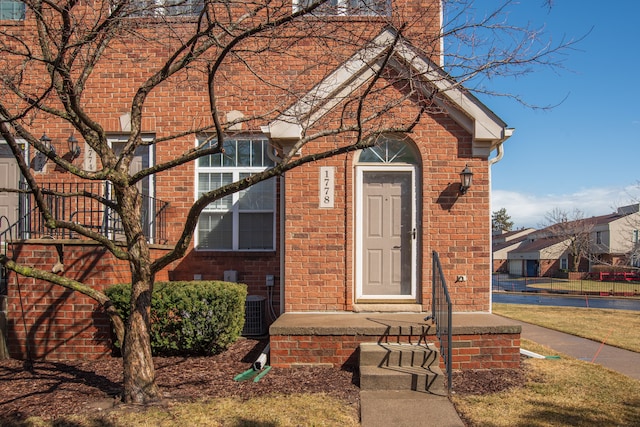 view of front of property with brick siding and a chimney