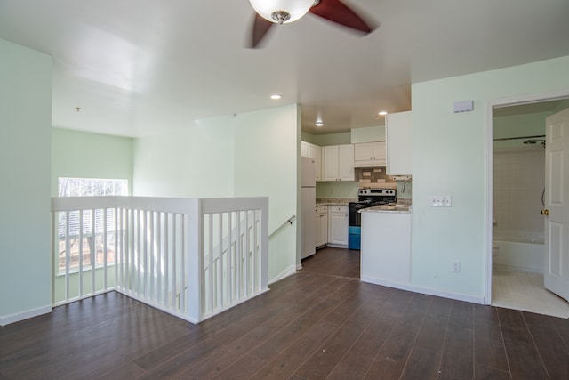 kitchen with open floor plan, freestanding refrigerator, dark wood-style floors, electric range, and white cabinetry