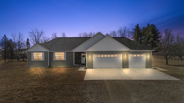 ranch-style house featuring a garage and concrete driveway