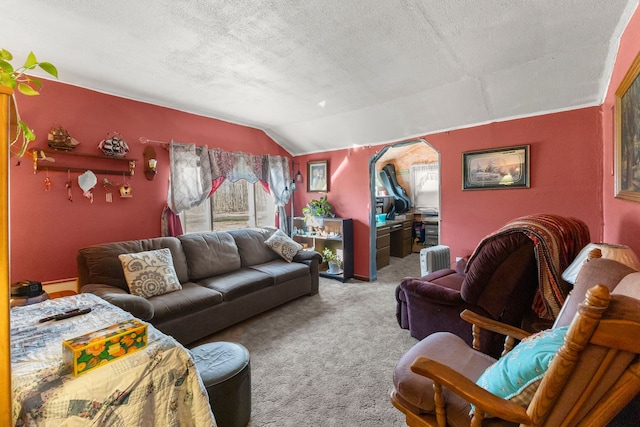 living room featuring a textured ceiling, carpet floors, arched walkways, and vaulted ceiling