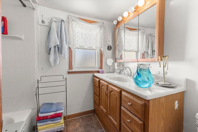 bathroom with baseboards, vanity, and tile patterned flooring