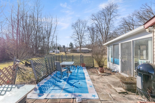 view of swimming pool featuring outdoor dining area, a patio, a grill, and a fenced backyard