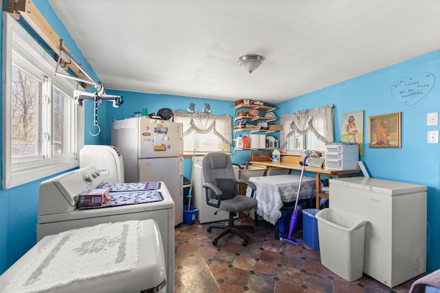 bedroom featuring washer / dryer, refrigerator, and freestanding refrigerator