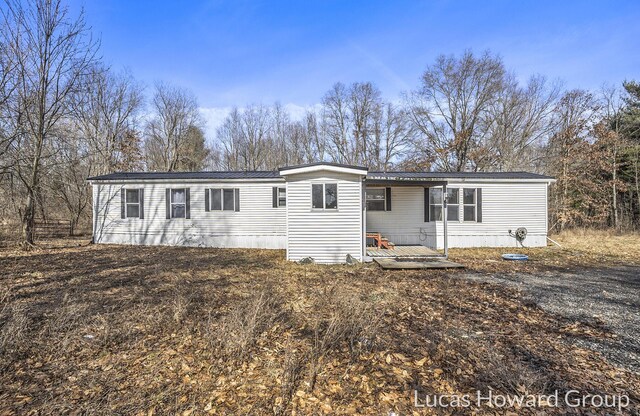 manufactured / mobile home featuring a wooden deck and metal roof