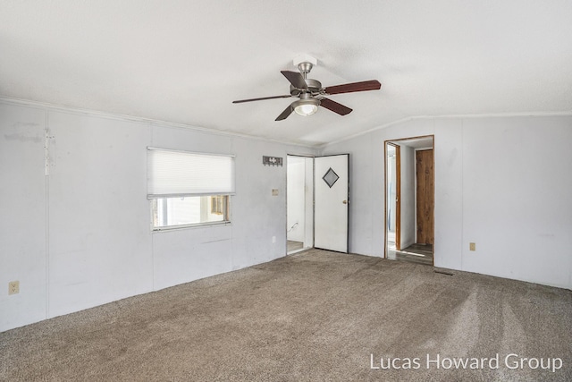 carpeted empty room with ceiling fan and vaulted ceiling