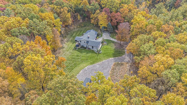 birds eye view of property with a view of trees