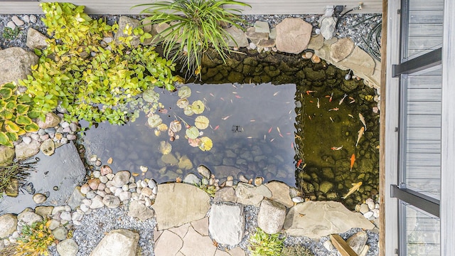 exterior details featuring a garden pond