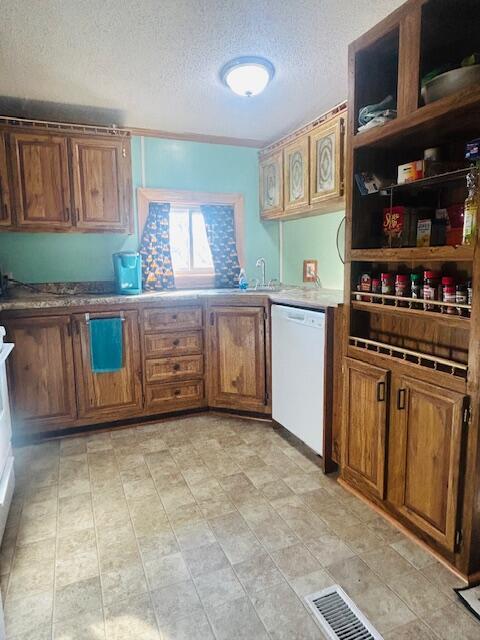 kitchen with visible vents, open shelves, a textured ceiling, brown cabinetry, and white dishwasher