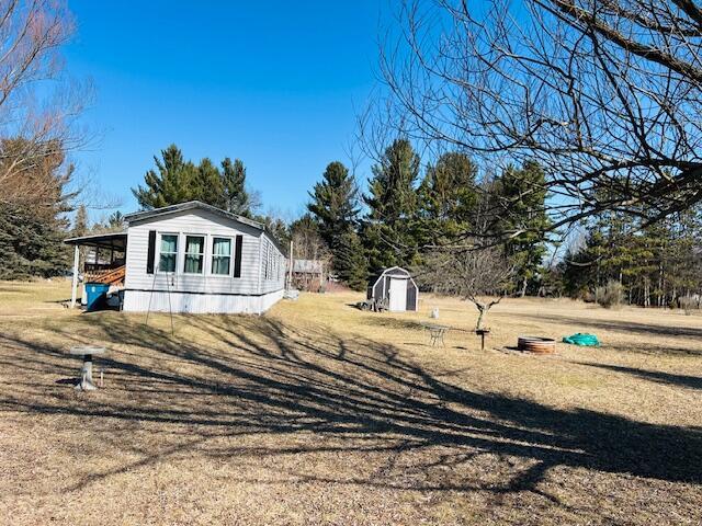 view of property exterior featuring an outdoor structure and a shed