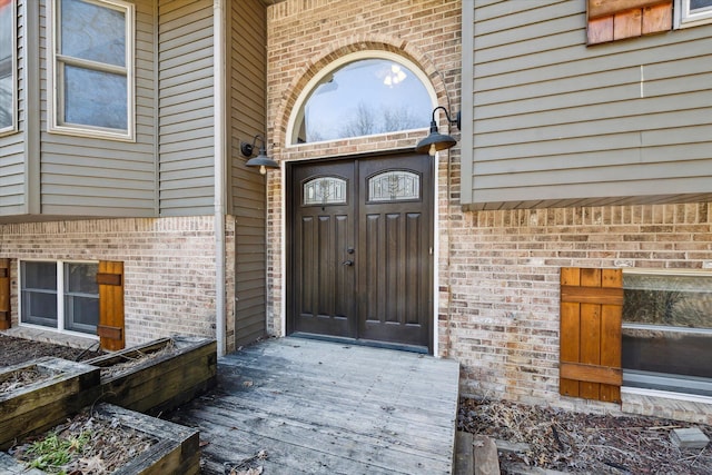 property entrance featuring brick siding