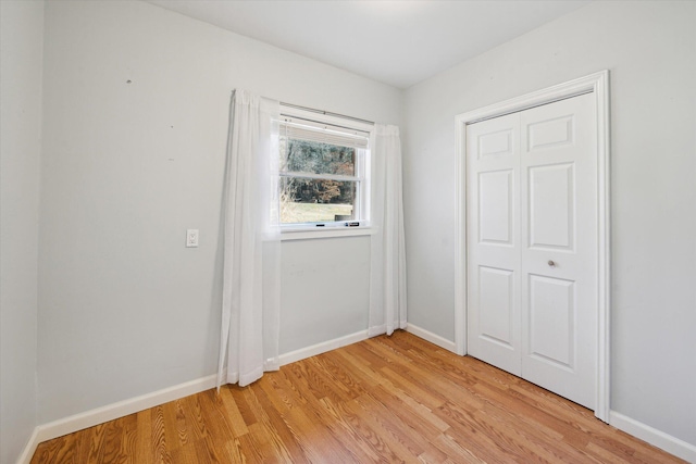 unfurnished bedroom featuring baseboards and light wood-style flooring