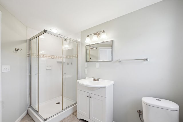 bathroom with toilet, a stall shower, vanity, and tile patterned flooring