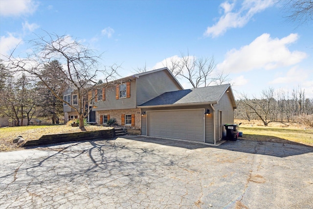 view of front facade with brick siding, a garage, driveway, and a shingled roof