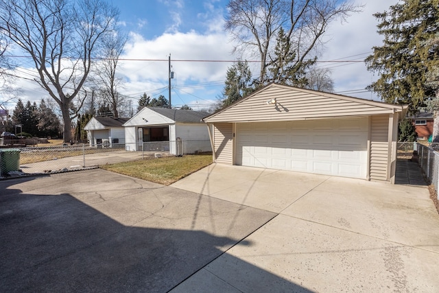 ranch-style house featuring a garage, an outdoor structure, and fence