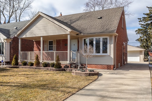 view of front of house featuring a front yard, covered porch, a shingled roof, an outdoor structure, and brick siding