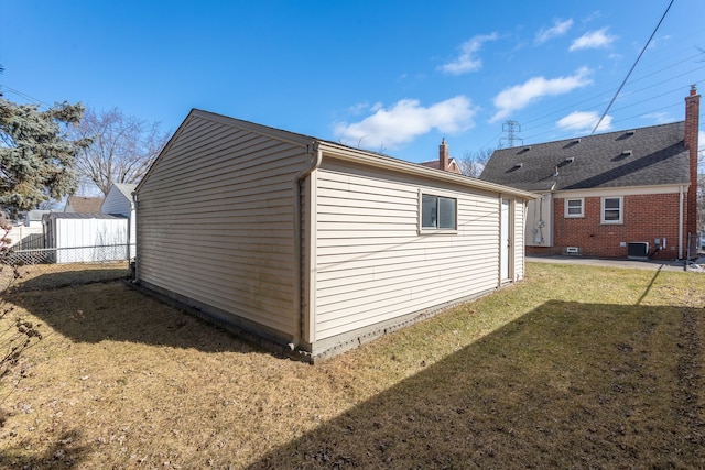 view of outbuilding with cooling unit and fence