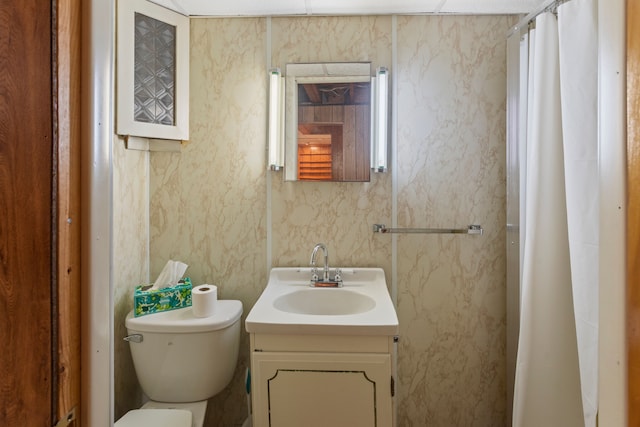 bathroom featuring vanity, toilet, a shower with curtain, and wallpapered walls