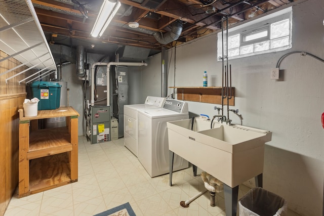 laundry room featuring a sink, light floors, laundry area, and washer and clothes dryer