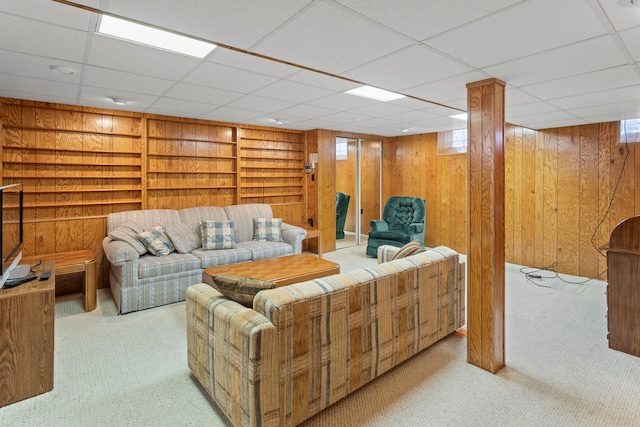 carpeted living area featuring built in shelves and wood walls