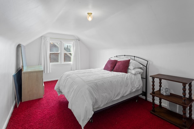 bedroom with carpet flooring, baseboards, and vaulted ceiling